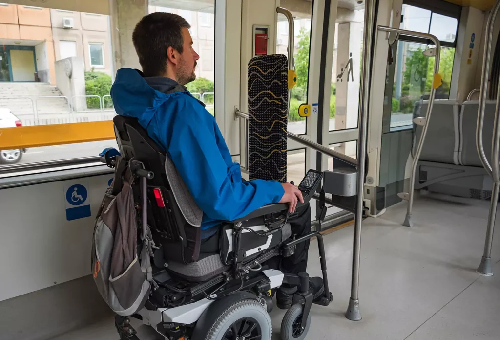 Disabled man in wheelchair on tram