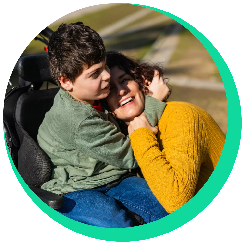 Mother hugging disabled son in wheelchair